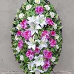 Оригинальный траурный венок 120см из искусственных цветов. Цветы: белые розы, малиновые розы, белые лилии. Зелень: папоротник. Каркас: хвоя.